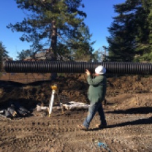 Casey of Bainbridge Parks carries a pipe for the new storm drain
