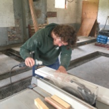 Willy Doyle of the Park District crafts window frames for the bakery